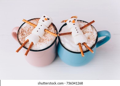 mugs with hot chocolate in which the men from the marshmallow relax. concept of a couple - Powered by Shutterstock