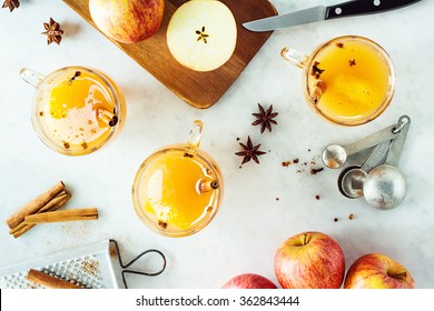 Mugs Of Hot Spiced Mulled Apple Cider With Ingredients On Countertop