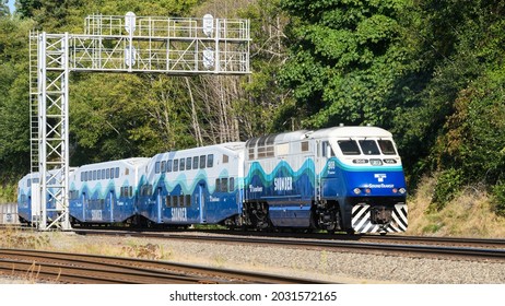 Mukilteo, WA, USA - August 23, 2021; A Northbound Sound Transit Sounder Commuter Train Passes Under A Signal Gantry North Of Mukilteo In Western Washington