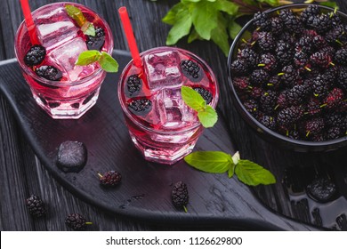 Mulberry Cocktail With Ice And Fresh Mint On A Black Wooden Table. Refreshing Summer Drink