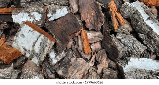 Mulching Flower Beds With Mulch From Natural Coniferous Bark. Natural Mulch Made From Coarse Wood Chips. Close-up Top View. Close Up For Background.