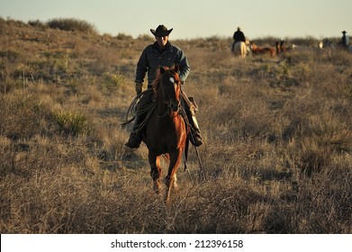 Muleshoe, Texas, USA, - March. 23. 2012: Cowboys on the horse in sunset