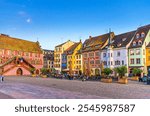 Mulhouse cityscape, Hotel de Ville The Town hall City hall, typical colorful buildings and street restaurant on Place de la Reunion square in old town Mulhouse city historic centre, Alsace, France