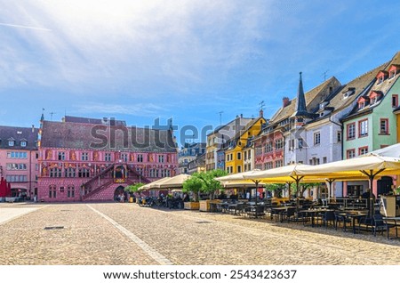Mulhouse cityscape, Hotel de Ville Town hall, typical colorful buildings and street restaurant on Place de la Reunion square in old town Mulhouse city historic centre, Alsace Grand Est region, France