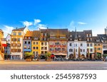 Mulhouse cityscape, typical houses colorful buildings and street restaurant outdoor café on Place de la Reunion square in old town Mulhouse city historic centre, Alsace Grand Est region, France