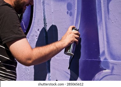 MULHOUSE - France - 07 June 2015 - closeup hand of painter during the BOZAR  graffiti festival - quay of sinners in Mulhouse