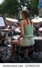 Mulhouse - France - 21 June 2022 - Portrait On Back View Of Blond Teenager Playing Drums In The Street