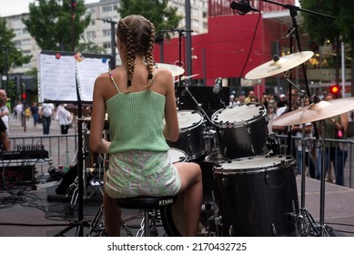 Mulhouse - France - 21 June 2022 - Portrait On Back View Of Blond Teenager Playing Drums In The Street