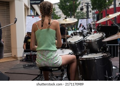 Mulhouse - France - 21 June 2022 - Portrait On Back View Of Blond Teenager Playing Drums In The Street