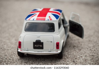 Mulhouse - France - 24 August 2018 - Closeup Of Old White Mini Cooper With British Flag On Roof On Stoned  Background