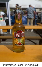 Mulhouse - France - 26 September 2021 - Closeup of desperados bottle of beer on a wooden table at the bar terrace