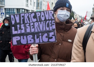 Mulhouse - France - 27 January 2022 - Portrait Of Young Woman Protesting In The Street With Placard In French : Du Fric Pour Les Services Publics, In English : Money For The Public Service