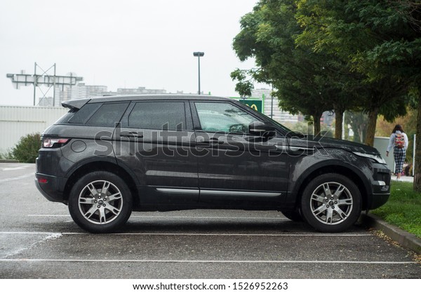 Mulhouse - France - 9 October\
2019 - view of black land rover 4X4 parked in the street by rainy\
day