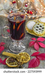 Mulled Wine, Mince Pies And Spices On Wooden Background