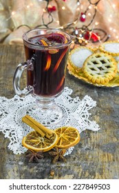 Mulled Wine, Mince Pies And Spices On Wooden Background