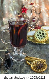 Mulled Wine, Mince Pies And Spices On Wooden Background