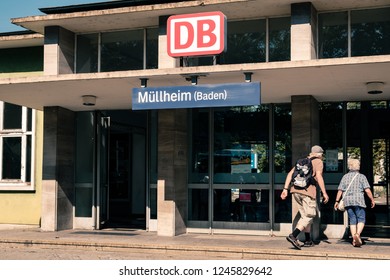 Mullheim, Baden-Wurttemberg, Germany - JULY 30 2018 : Senior Couple Entering The Mullheim Railway Station. Man With Backpack. Southwest Region Of Germany In Black Forest