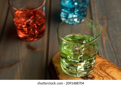 Multi Color Cocktails Or Drinks On Wood With Multi Color Objects Scattered On Table