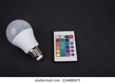 Multi Color Led Bulb With A Remote Control On A Black Background