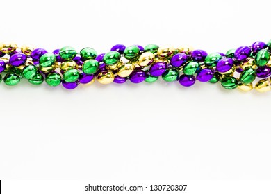 Multi Color Mardi Gras Beads On White Background.