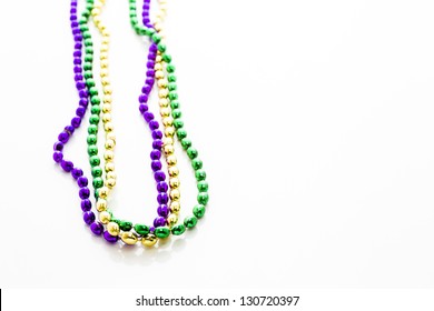 Multi Color Mardi Gras Beads On White Background.