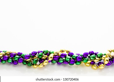 Multi Color Mardi Gras Beads On White Background.