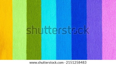 multi colored background. knitted wool fabric texture with colorful stripes