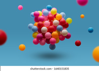 Multi Colored Balls Levitation In Mid Air On Blue Background. 