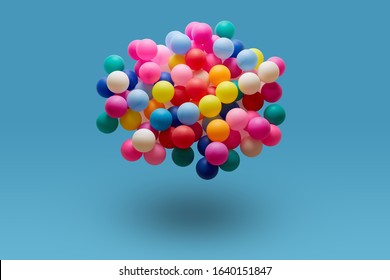 Multi colored balls levitation in mid air on blue background. 