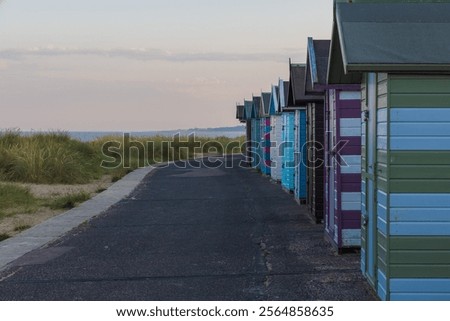 Multi colored beach huts on the lower promenade in Lowestoft Suffolk.
