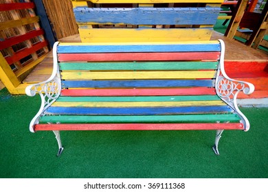Multi colored bench made from different painted wooden boards