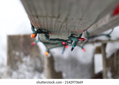 Multi Colored Christmas Lights Wrapped Around A Pole Outside