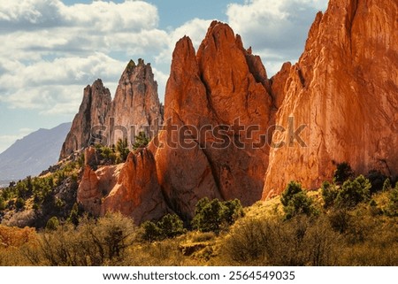 MULTI COLORED JAGGED ROCK FORMATIONS AND A NICE CLOUDYSKY AT THE GARDEN OF THE GODS IN COLORADO SPRINGS COLORADO