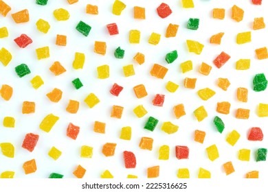 multi colored pineapple sweet pieces isolated on white background, pattern of colored candied pieces, used as filling in confectionery, baking or as additive in muesli for breakfast