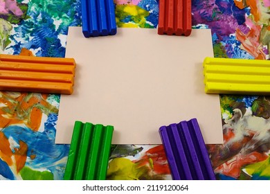 Multi Colored Rectangle Pieces Of Plasticine, Piece Of Pink Paper Lie On A Cardboard With Plasticine Abstract Painting, Background