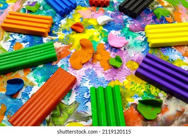 Multi colored rectangle pieces of plasticine lie on a cardboard with plasticine abstract painting, abstract background
