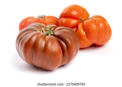 Multi colored red heirloom tomatoes with distinctive wrinkles and creases and irregular shape isolated on white - Powered by Shutterstock