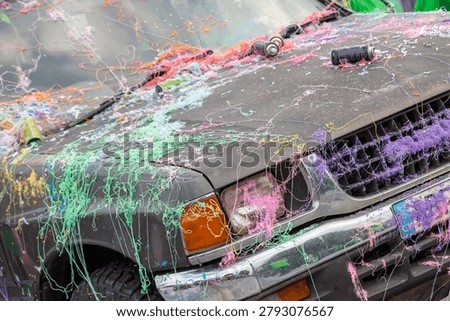 Multi colored silly string on car at Carnival Parade