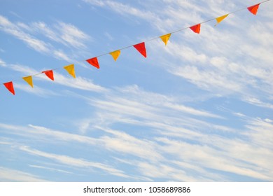 Multi Colored Triangular Flags Hanging in the Sky