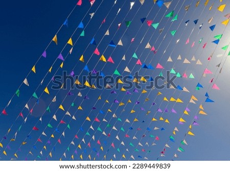 Multi Colored Triangular Flags Hanging in the Sky at an Outdoor Celebration Party.