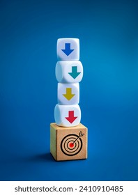 Multi colors down arrows on white block stack soaring down on target icon on wood blocks, decrease business graph step on blue background. Retire from work, step down career, business concepts.