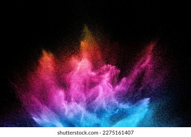 Multi colour powder explosion on black background. Launched colourful dust  particles splashing.