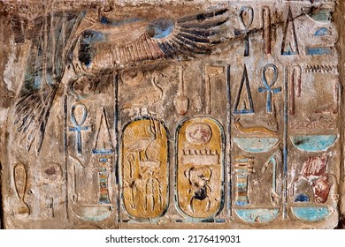 A multi coloured mural from Karnak temple in Luxor, with vulture goddess Mut and hieroglyphic writing with the cartouches of Thtuthmosis III - Shutterstock ID 2176419031