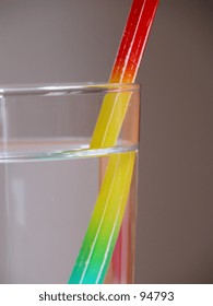 Multi Coloured Pencil In A Glass Of Water, Depicting Refraction, Illusion.