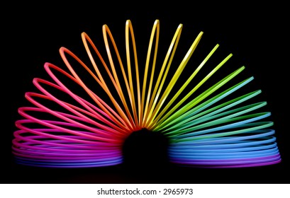Multi coloured rainbow spring, set against black background