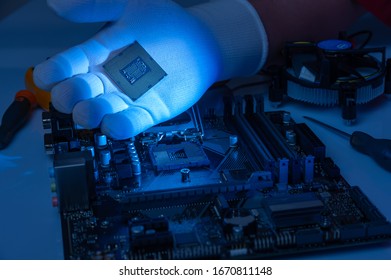 Multi Core CPU Installation On Computer Motherbord. PC Assembly Or Upgrade On Modern Chipset. Electronic Concept With Processor, Low Lights