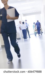 Multi Ethnic African American And Asian Chinese Clinical Doctor And Nursing Staff With Patient In Modern Hospital Center