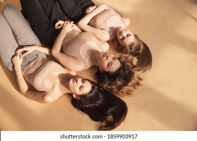 Multi Ethnic Beauty Fashion Hair, Face And Head Skin Care. Group Of Woman Lies On Beige Background Studio.