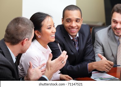 Multi Ethnic Business Team At A Meeting. Interacting. Focus On Woman