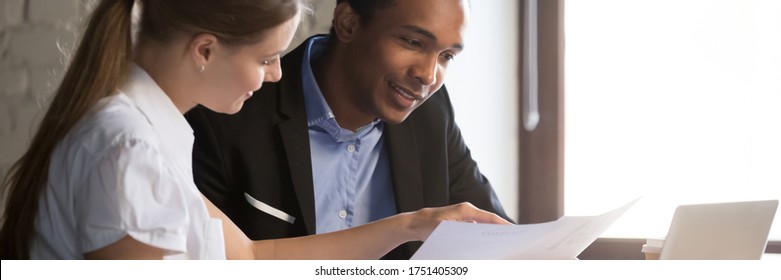Multi ethnic colleagues analyzing report, financial advisor consult client people discuss agreement terms during meeting in office. Team work concept. Horizontal photo banner for website header design